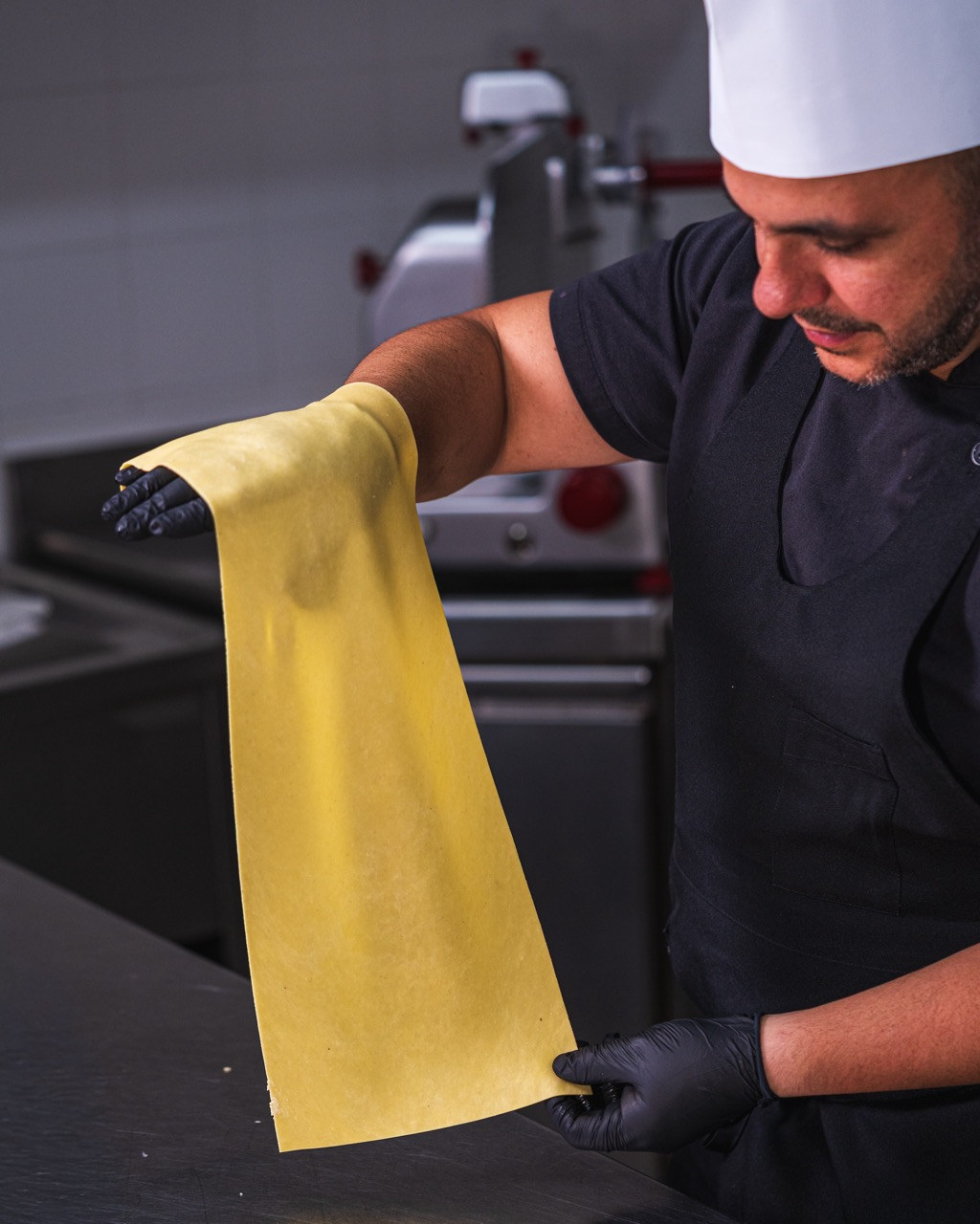 Chef rolling fresh handmade pasta