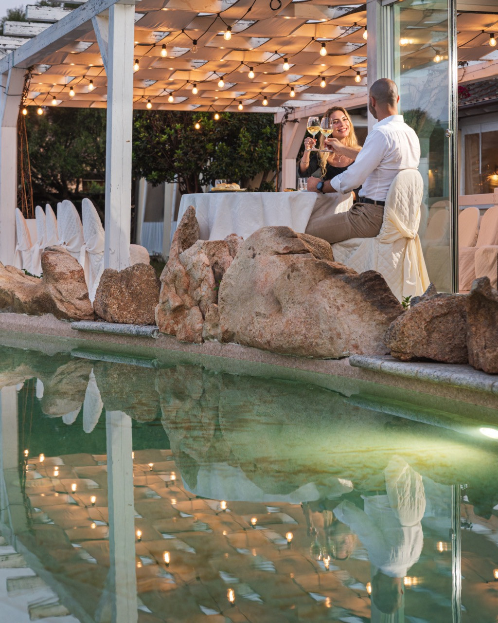 Evening dining under the lights by the pool